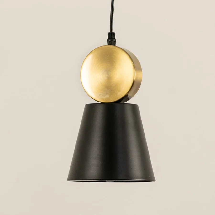 Black metal pendant light with gold sphere accent illuminated to showcase luxury modern ceiling lighting appeal.
