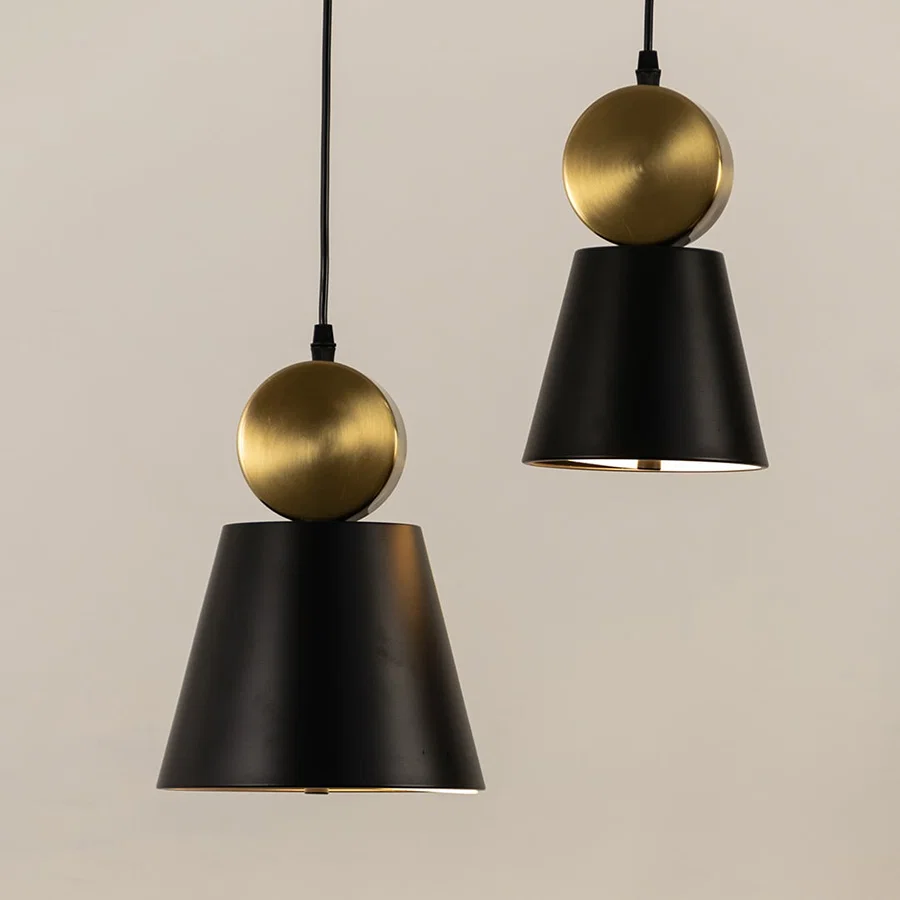Black and gold metal pendant lights illuminated to display contemporary decorative ceiling lighting with elegant styling.