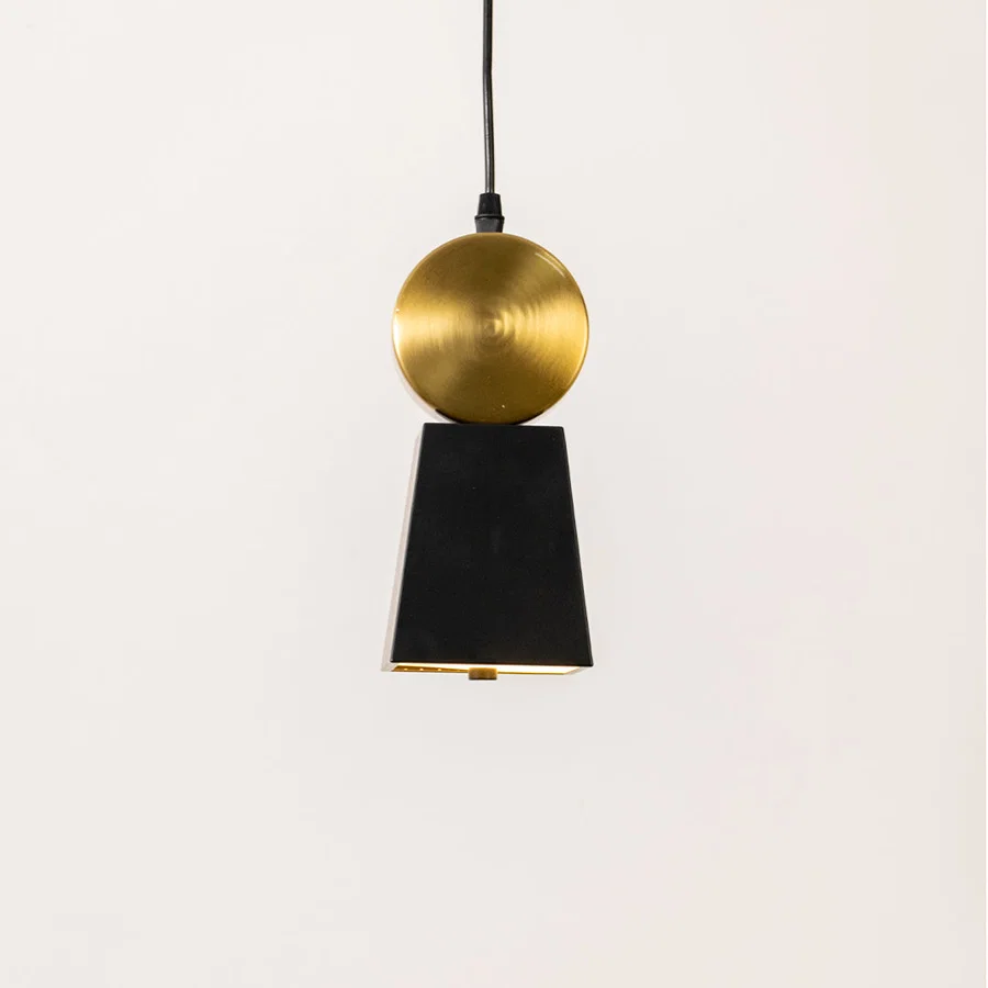 Minimal pendant light in gold and black metal finish with cone design for kitchen or dining decor lighting white background.