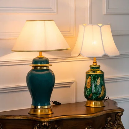 Green ceramic lamps with golden bases and fabric shades turned on glowing in elegant grouped display.