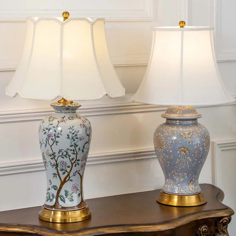 Table lamps with elegant floral bases and white shades placed on a wooden table adding charm and warmth to classic home decor.