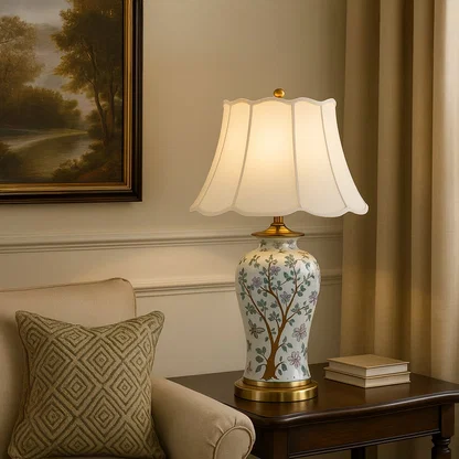 Artisan floral ceramic table lamp with gold detailing and cream shade adds artistic flair to both traditional and modern spaces.