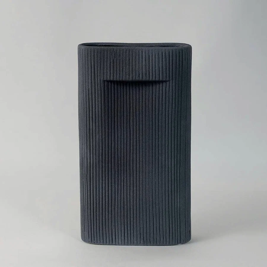 Elegant tall ceramic vase in matte black finish with vertical ribbed design perfect for living room and office decoration.