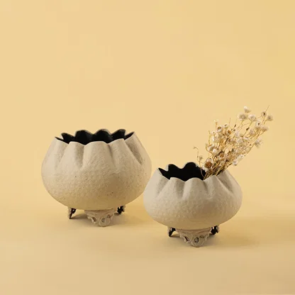 Set of two textured white bowl planters with dried buds for elegant modern home decor and minimalist tabletop style.