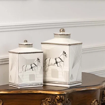 White ceramic jars with crane artwork displayed on console for elegant minimalist décor styling.