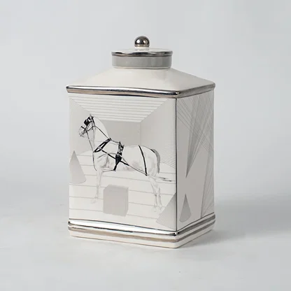 White ceramic jar with crane artwork shown on simple background for elegant luxury home décor styling.