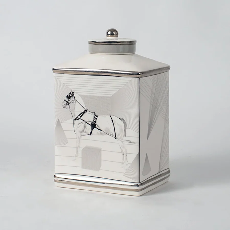 White ceramic jar with crane artwork shown on simple background for elegant luxury home décor styling.