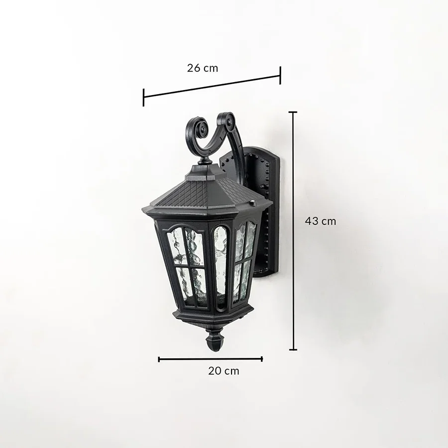 Outdoor wall light with ornate lantern design black frame and glass panels shown with 43 cm height 26 cm width 20 cm depth.