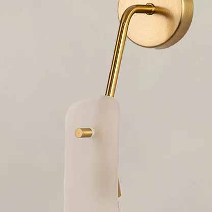 Closeup of gold metal wall light with frosted glass shade on white background ideal for bedroom hallway and modern interior decor.