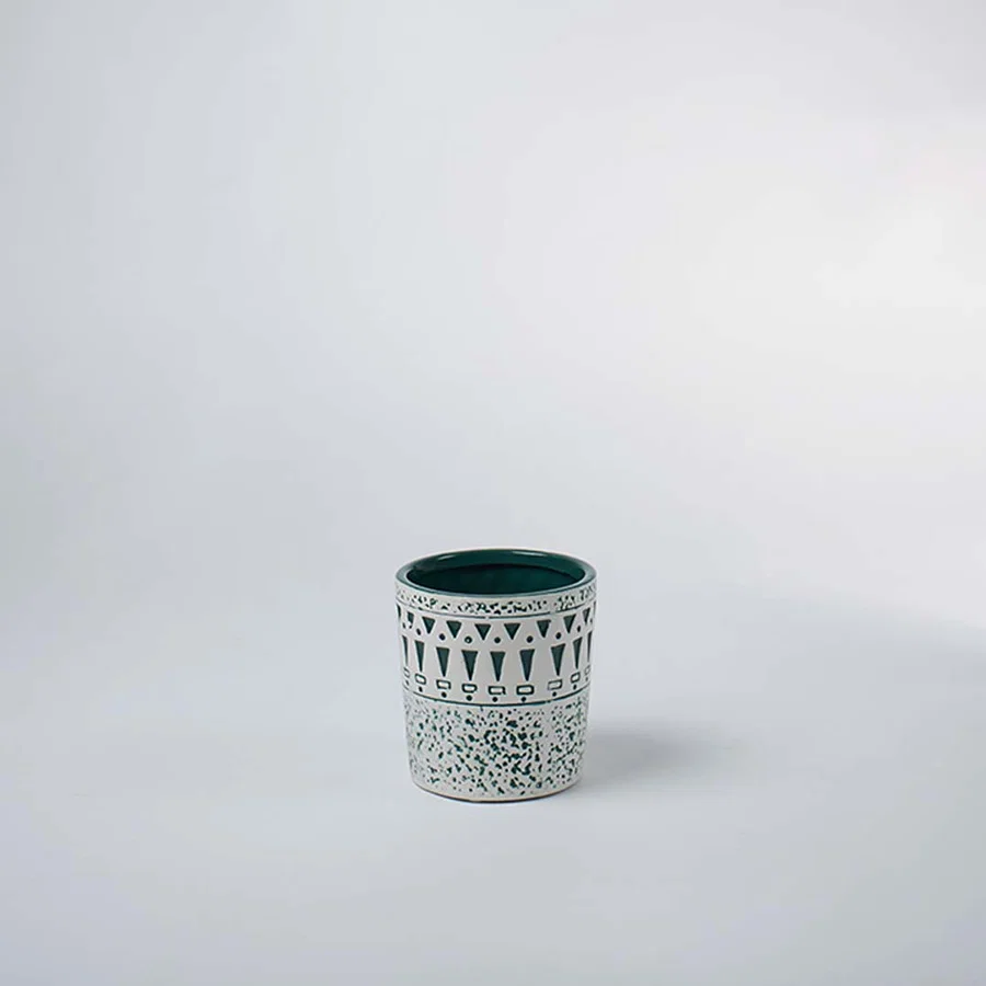 Small ceramic tumbler vase featuring a textured white distressed tribal pattern over a teal base on clear white background.