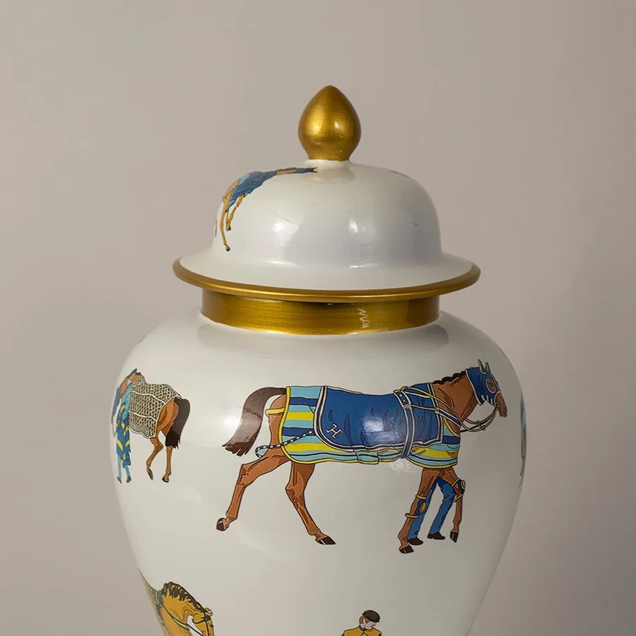 Detailed closeup of white ceramic jar showing intricate horse artwork with gold rim and glossy decorative finish.