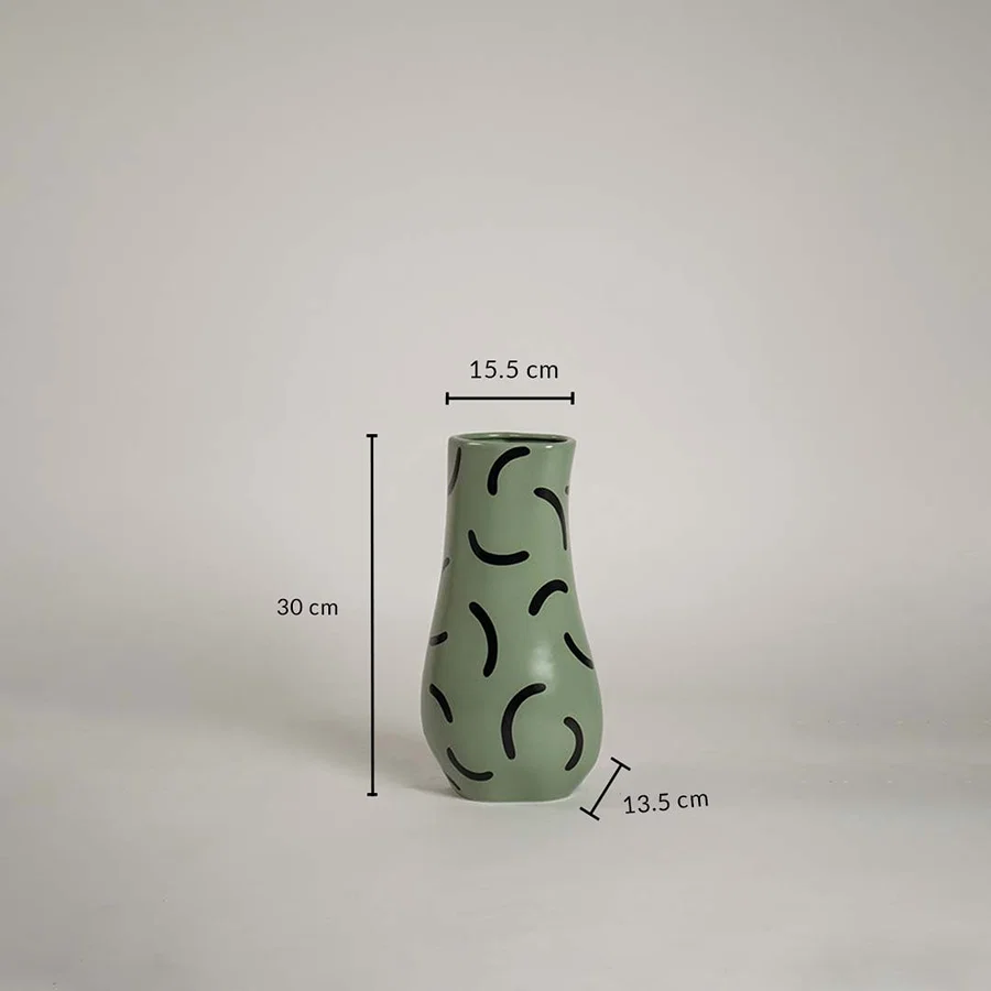 Green ceramic vase with black abstract pattern measuring 30 cm height 15 cm top width and 13 cm base width shown with exact dimensions.