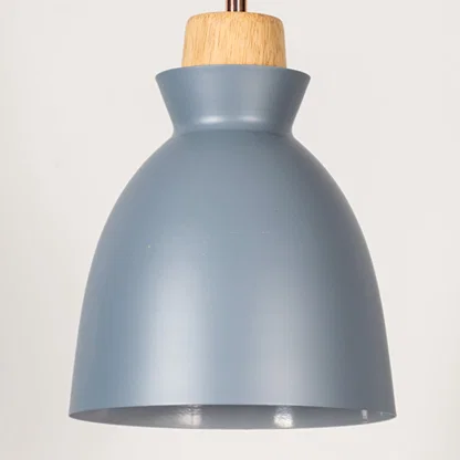 Blue metal pendant light with natural wood detailing showcasing smooth dome shape and modern Scandinavian design appeal.
