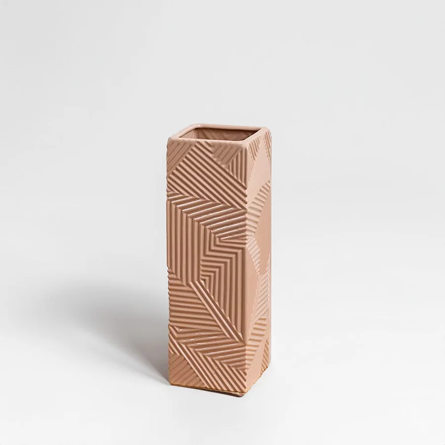 Beige ceramic decorative vase with geometric carved pattern for shelf styling and contemporary home decor displays.