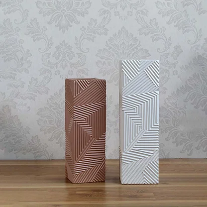 A collection of textured brown geometric vases displayed together highlighting their unique patterns and contemporary decorative appeal.
