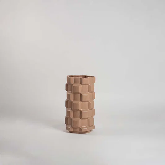 Natural beige ceramic decorative vase with stacked geometric design for modern shelf styling and home decor display.