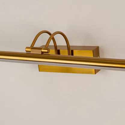 Gold metal picture light with refined curved mounting detail showcasing premium craftsmanship and modern design appeal.