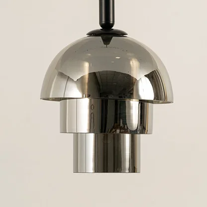 Closeup of smoked glass pendant light with metallic finish for elegant kitchen and dining room decor styling.