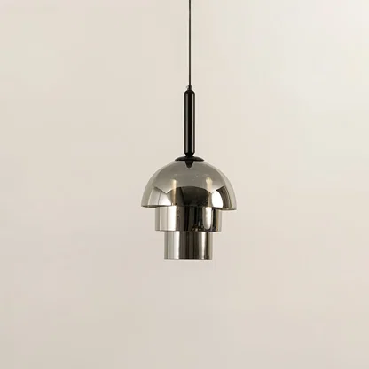 Chrome metal pendant light illuminated to showcase sleek modern ceiling lighting with reflective decorative appeal.
