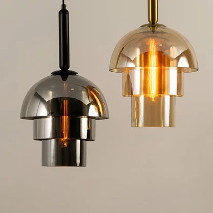Chrome and amber glass pendant lights illuminated to showcase elegant modern ceiling lighting with luxury styling.