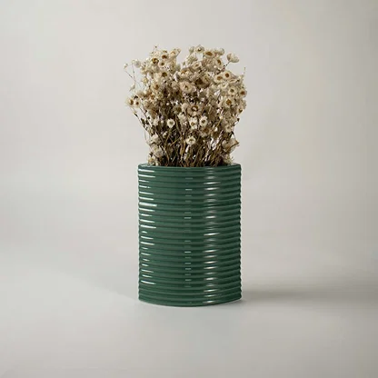 Tall dark green ceramic planter placed in a stylish interior setting perfect for living rooms hallways and modern decor accents.