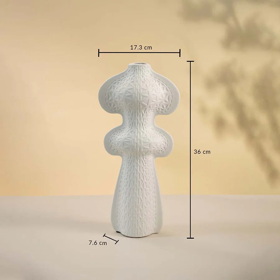 White sculptural vase displayed on a neutral surface measuring 36 cm in height and 17 cm in width with a 7 cm base.