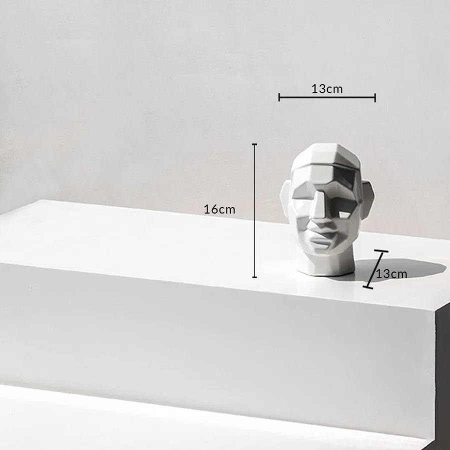 Geometric face sculpture with dimensions 16 cm height 13 cm width and 13 cm depth shown on a white surface with measurement markers.