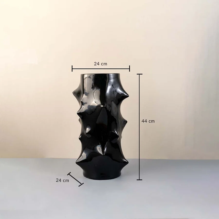 Black ceramic vase with glossy sculptural surface measuring 44 cm height and 24 cm width shown with dimension markings.