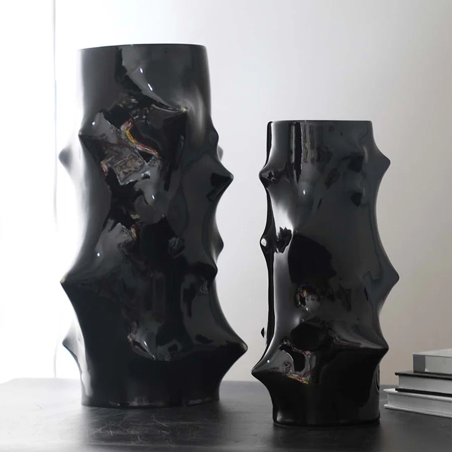 Collection of black ceramic vases with artistic sculptural shapes styled together for modern luxury table decor inspiration.