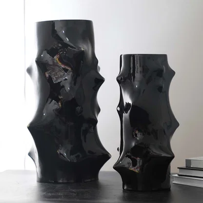 Grouped image of sculptural black ceramic vases with textured abstract forms styled together for bold modern home decor accents.