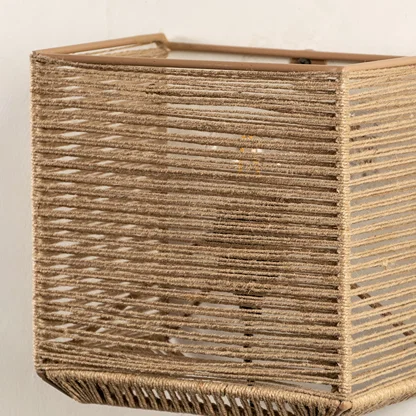Detailed closeup of jute wall lamp showcasing its fine woven texture and expert craftsmanship that adds depth and organic appeal.