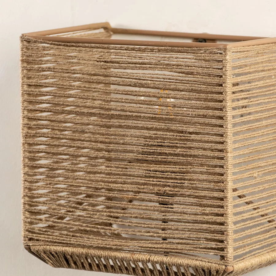 Detailed closeup of jute wall lamp showcasing its fine woven texture and expert craftsmanship that adds depth and organic appeal.