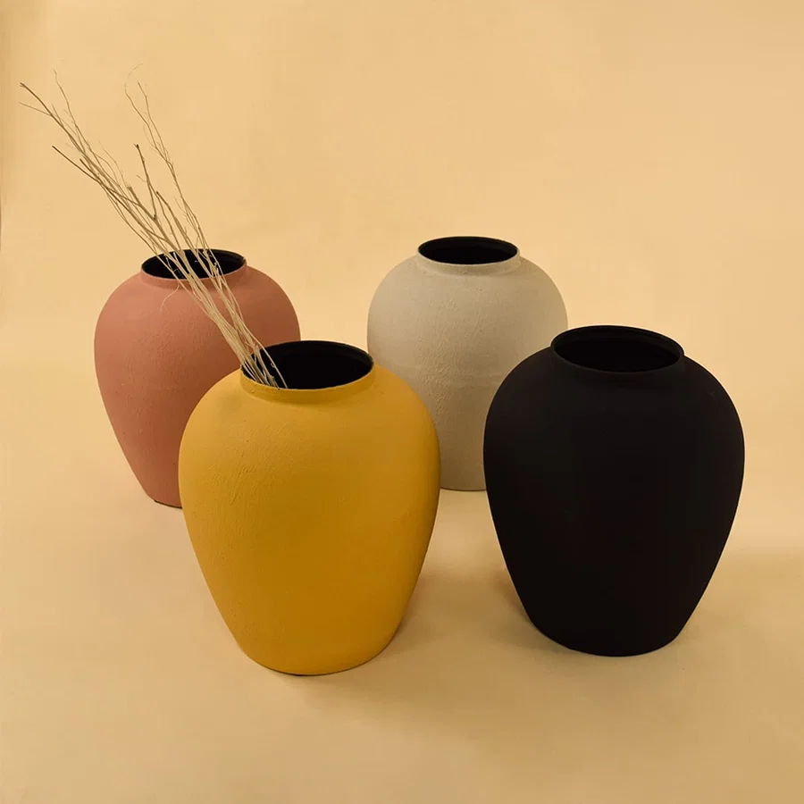 Set of yellow textured metal vases displayed together creating a vibrant cohesive look for living and dining spaces.