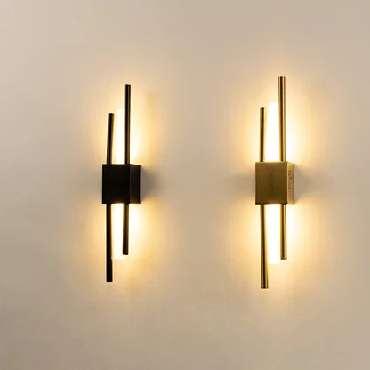 Modern gold metal wall lights glowing on white wall for luxury bedroom hallway and living room decor styling.