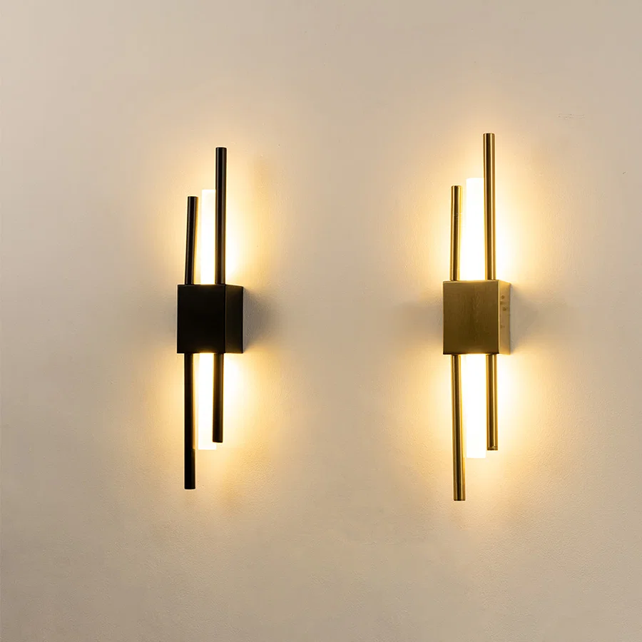 Modern gold metal wall lights glowing on white wall for luxury bedroom hallway and living room decor styling.