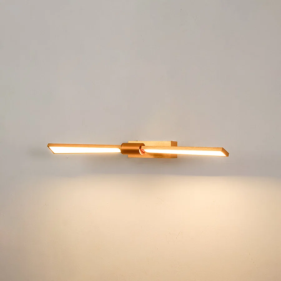 Elegant wall light in gold metal finish with linear bar design for bathroom or vanity decor lighting white background.