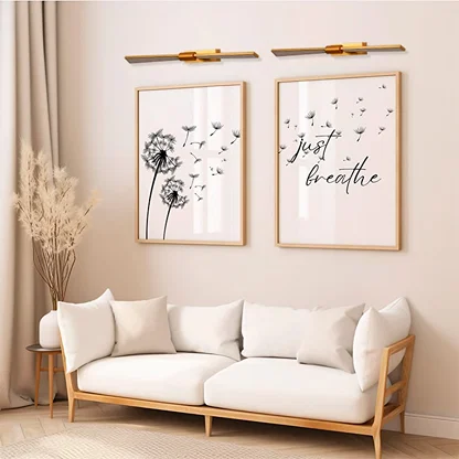 Gold metal picture light highlighting framed artwork with focused illumination adding gallery style elegance to modern spaces.