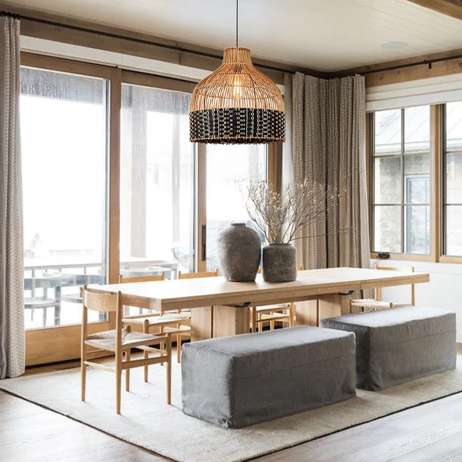 Handwoven rattan pendant light above dining area creating cozy ambiance with timeless boho appeal.