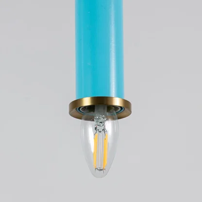 Blue metal pendant light with brass detailing showcasing sleek cylindrical form and modern Scandinavian style appeal.