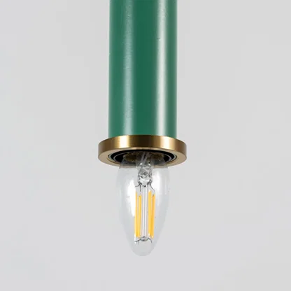 Green metal pendant light with brass detailing showcasing sleek cylindrical form and modern Scandinavian style appeal.