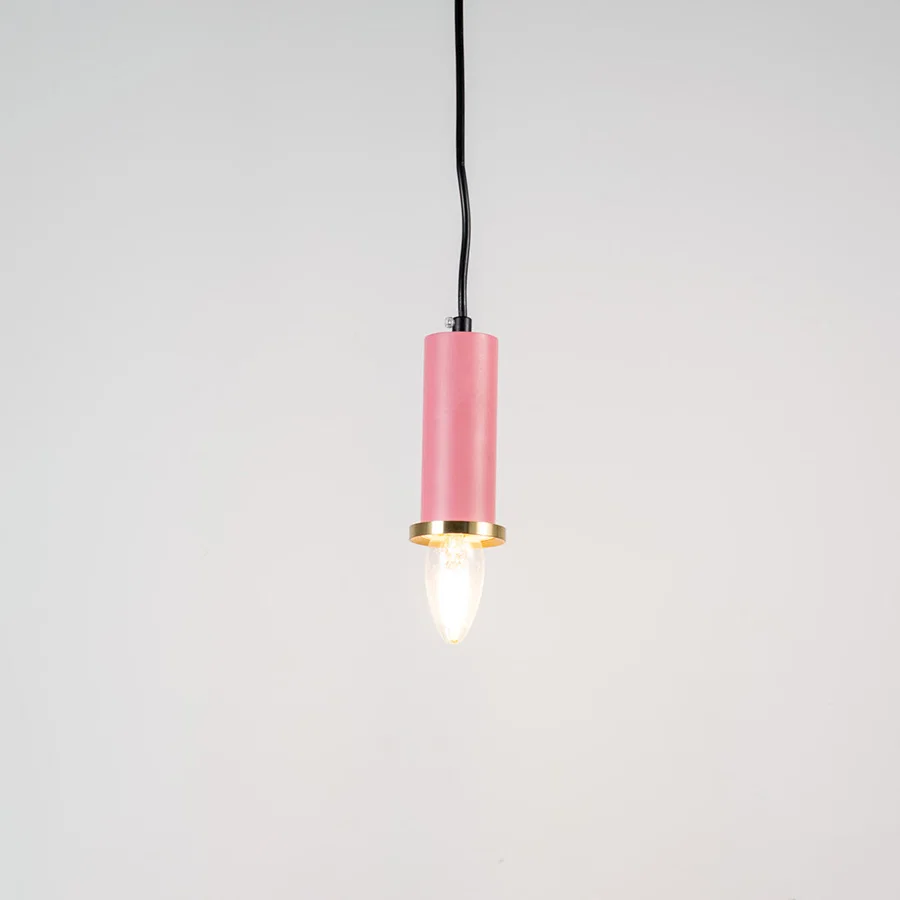 Pink metal pendant light with brass accents and minimalist cylindrical design for contemporary ceiling lighting decor.
