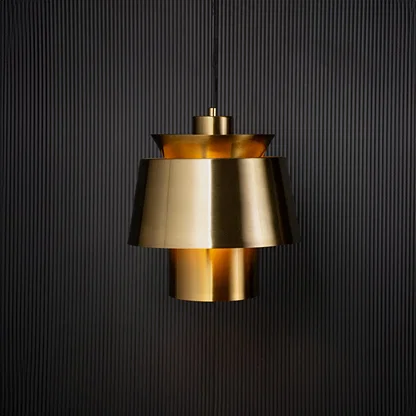 Contemporary gold pendant light turned on with black background for home lighting.