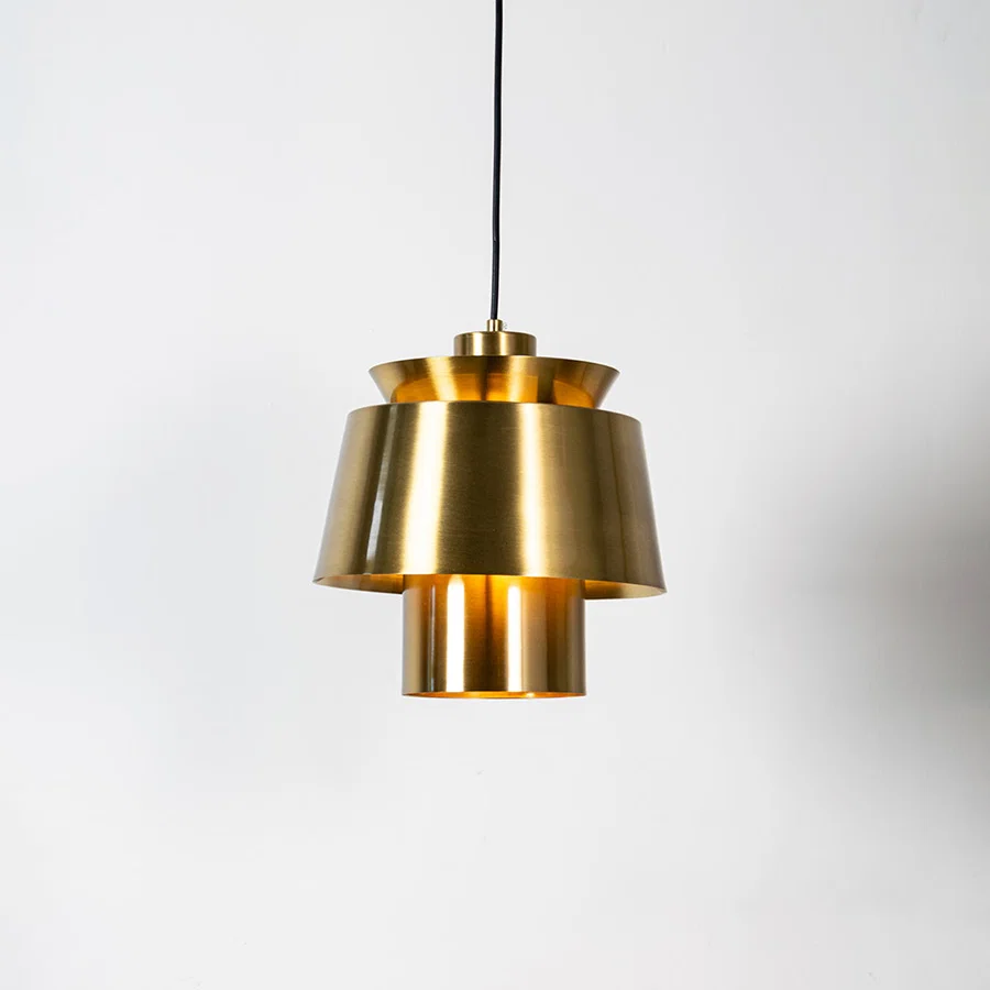Brass metal pendant light with layered geometric design and brushed finish for sophisticated ceiling lighting decor.