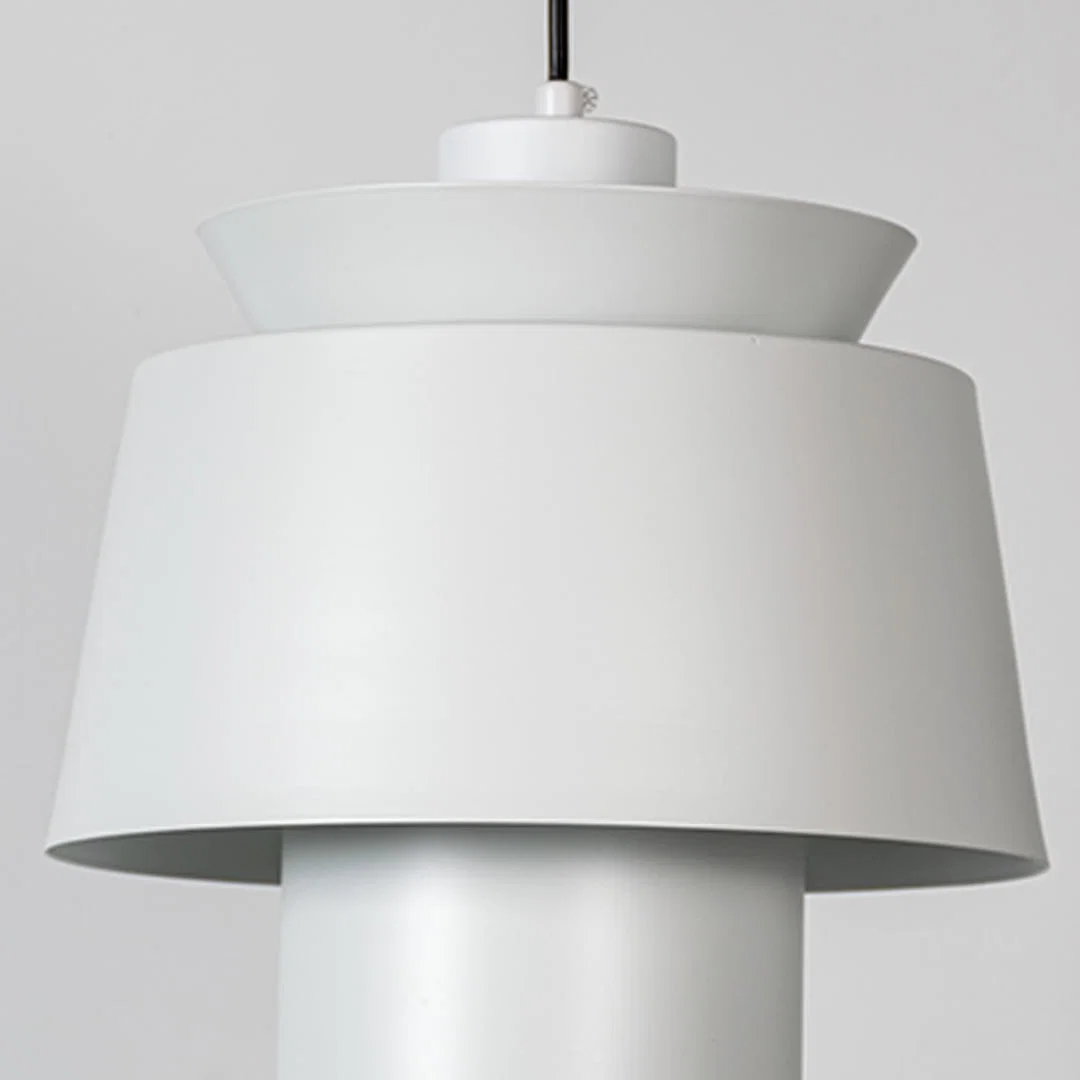 White metal pendant light featuring layered sculptural form and smooth matte finish showcasing refined modern craftsmanship.