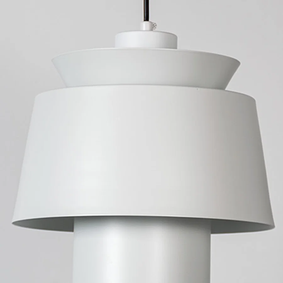 White metal pendant light featuring layered sculptural form and smooth matte finish showcasing refined modern craftsmanship.