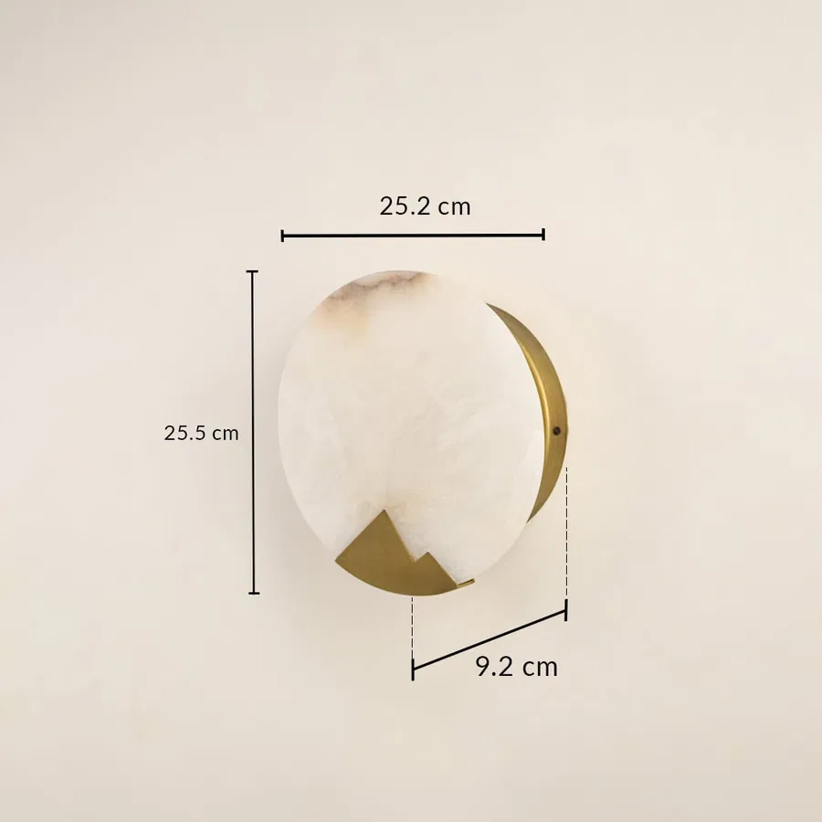 Designer marble wall light measuring 25 cm with brass detailing ideal for modern interiors needing warm ambient wall illumination.