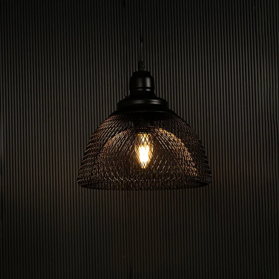 Elegant black mesh pendant light illuminated against dark background highlighting artistic industrial style and fine craftsmanship.