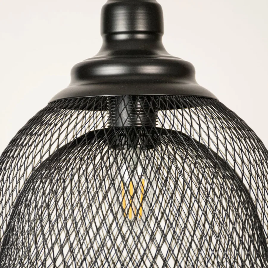 Black metal mesh pendant light closeup highlighting intricate wire detailing and premium industrial lighting craftsmanship.
