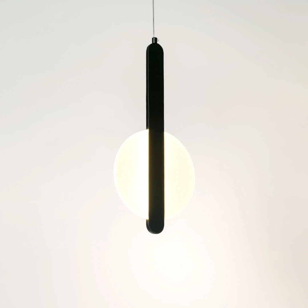 Illuminated black linear pendant light with frosted diffuser creating soft ambient lighting indoors.