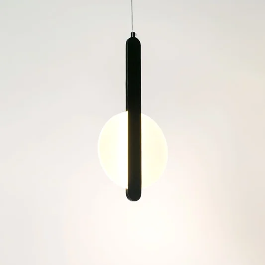Illuminated black linear pendant light with frosted diffuser creating soft ambient lighting indoors.